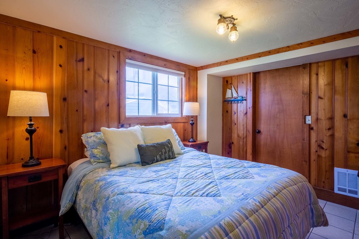 Downstairs bedroom with queen bed is warm and cozy.