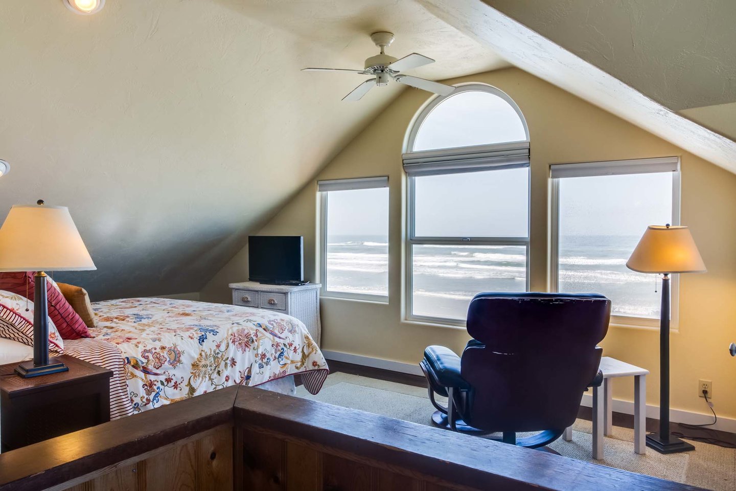 The primary bedroom upstairs has a king bed and wonderful ocean views!
