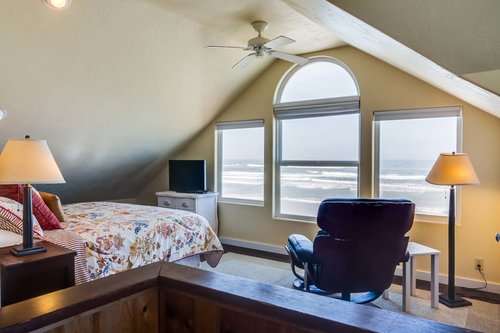 The primary bedroom upstairs has a king bed and wonderful ocean views!