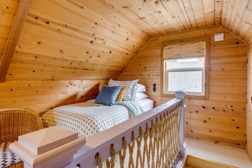 Twin bed is tucked under the eaves for an extra sleeping spot!