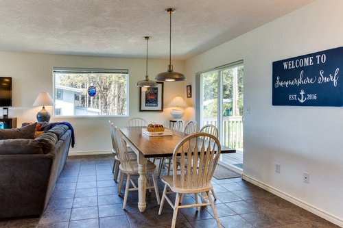 A large artisan table, handcrafted by the homeowner with seating for eight and ocean view!