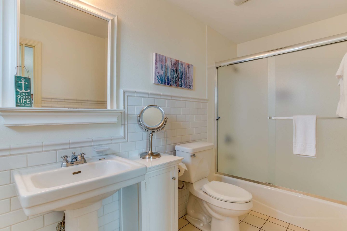 A clean and modern bath with tub-shower and custom tile work.
