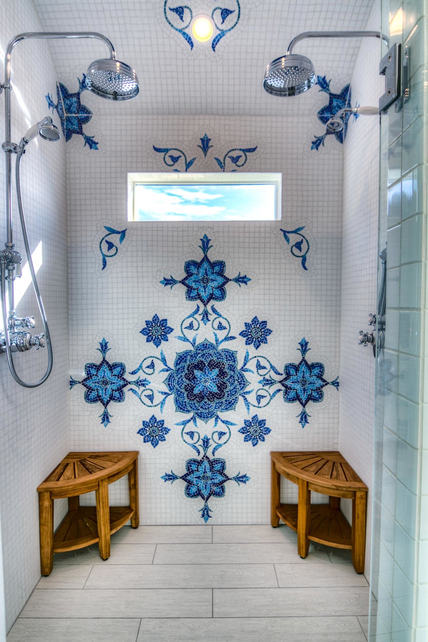 Gorgeous tile work in this double shower head walk in shower.