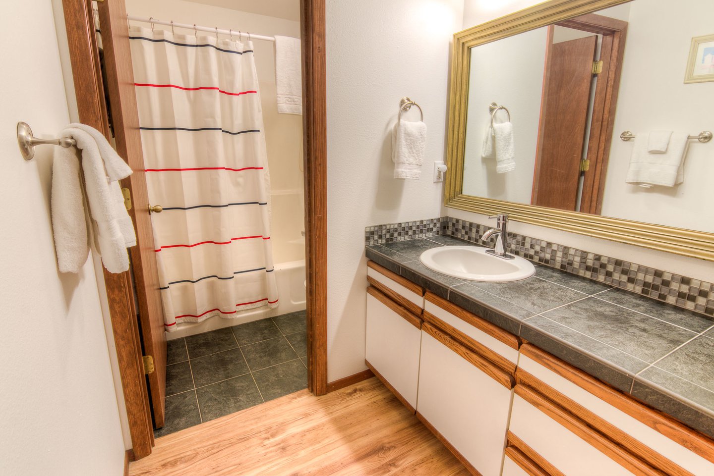 The bath is spacious with a tub/shower combination.
