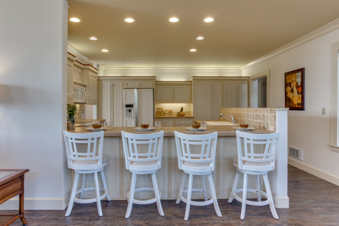 Comfy bar stools invite you to chat and watch the cook in the kitchen!